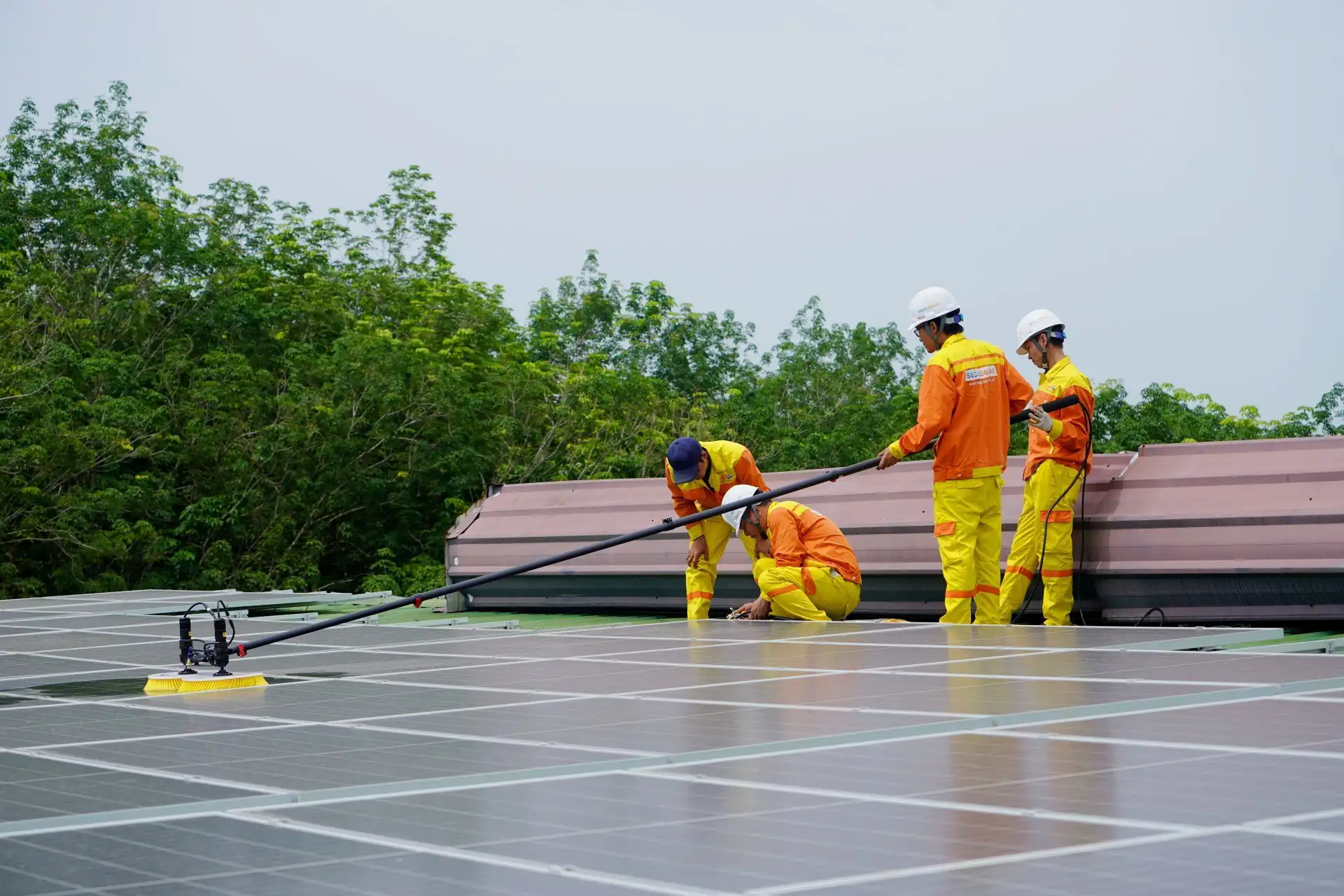 A group of men are working on a solar panel roof.